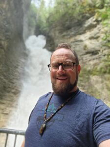 reiki man selfie in front of beautiful waterfalls